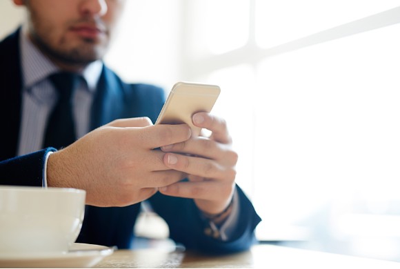 Businessman reviewing his phone
